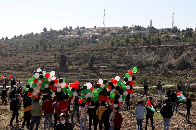 Palestinian demonstrators hold balloons during a protest against US Secretary of State Mike Pompeo's visit, near the Israeli settlement of Psagot in the Israeli-occupied West Bank. Reuters