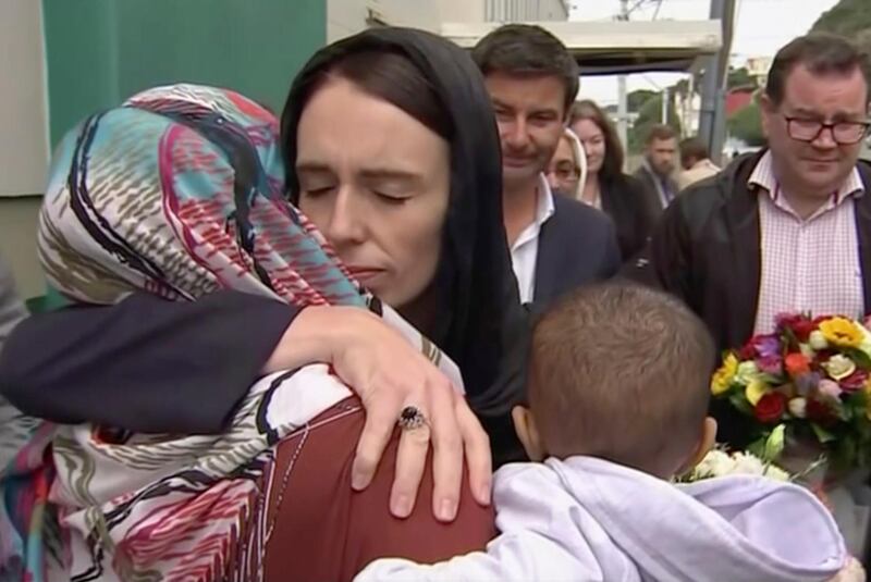 New Zealand's Prime Minister Jacinda Ardern hugs and consoles a woman as she visited Kilbirnie Mosque to lay flowers among tributes to Christchurch attack victims, in Wellington. TVNZ via AP