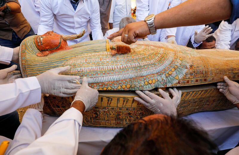 Archaeologists remove the cover of an ancient painted coffin discovered at Al Asasif Necropolis in the Vally of Kings in Luxor, Egypt. Reuters