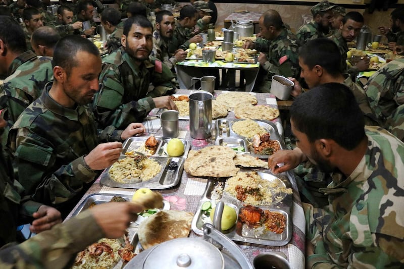 Iftar for Afghan National Army soldiers as they break the Ramadan fast at their base in Herat, western Afghanistan.  EPA
