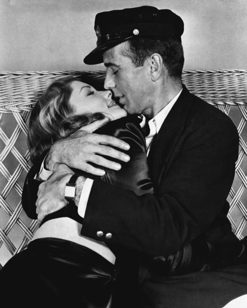 This 1944 file photo originally released by Warner Bros. shows actor Humphrey Bogart, right, holding actress Lauren Bacall in a scene from, To Have and Have Not. AP, Warner Bros. Pictures, File
