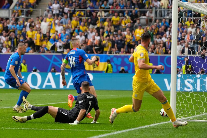 Ukraine's Roman Yaremchuk, right, scores his side's second goal against Slovakia. AP