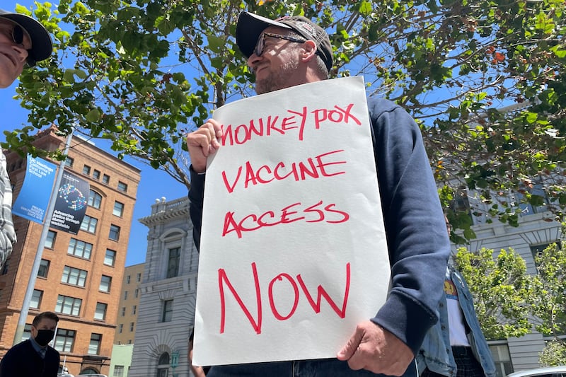 A man holds a sign calling for increased access to the monkeypox vaccine during a protest in San Francisco. AP