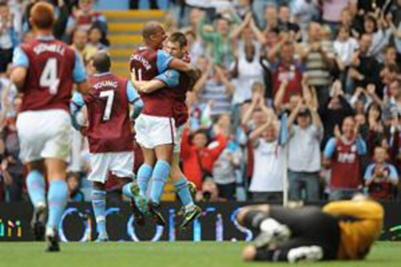 James Milner, right, celebrates his goal with Villa teammate Gabriel Agbonlahor.