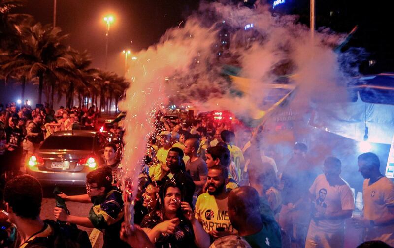 Supporters of Jair Bolsonaro, celebrate in front of the candidate's house in Rio de Janeiro. EPA
