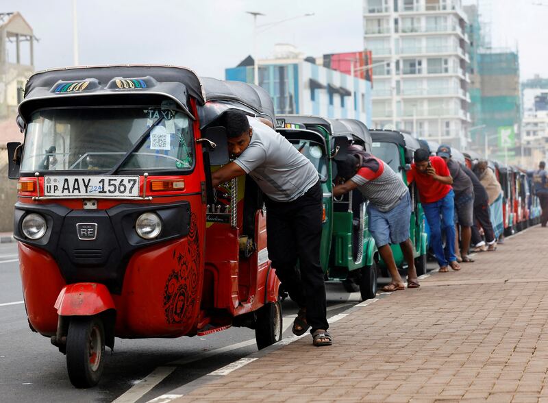 Drivers of auto rickshaws queue to buy petrol from a station in Colombo, Sri Lanka. Reuters