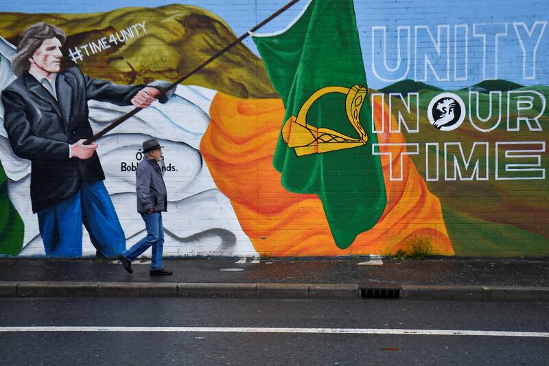 A man walks past a nationalist mural in Belfast ahead of local elections in Northern Ireland.  Reuters