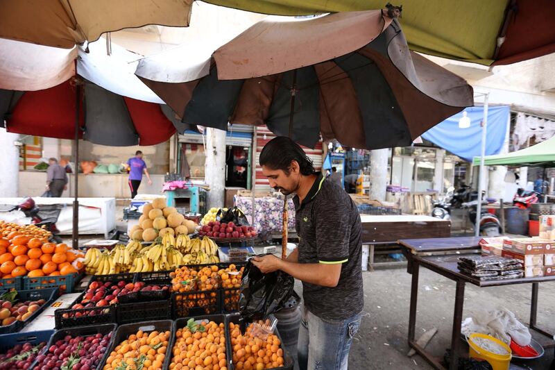 An Iraqi grocer waits for customers at his road side stall in Baghdad's Sadriya district, Iraq.  EPA