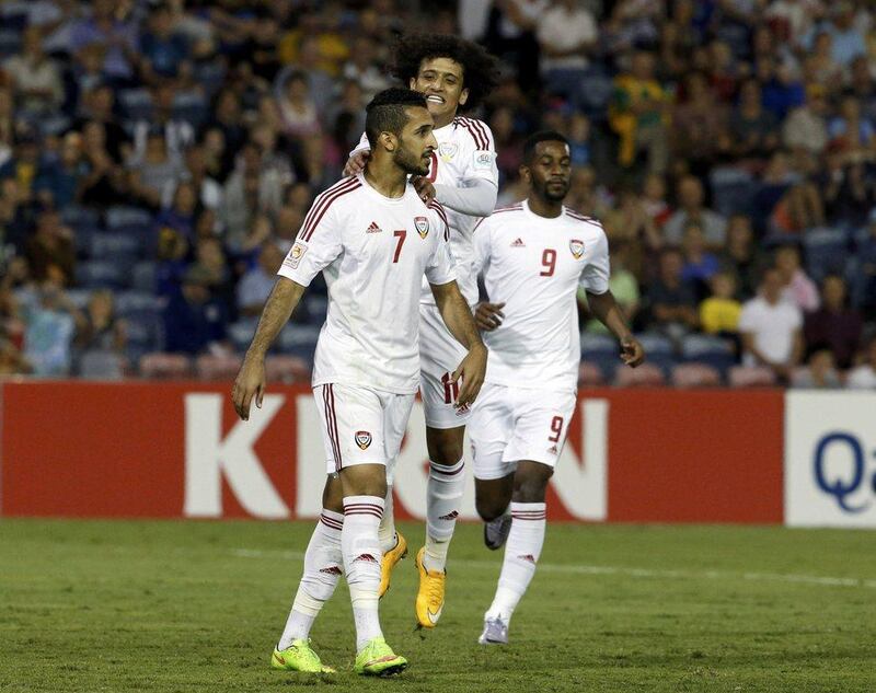 Omar Abdulrahman, centre, and Abdulaziz Haikal, right, congratulate Ali Mabkhout after his penalty earned UAE a 3-2 lead against Iraq. Jason Reed / Reuters