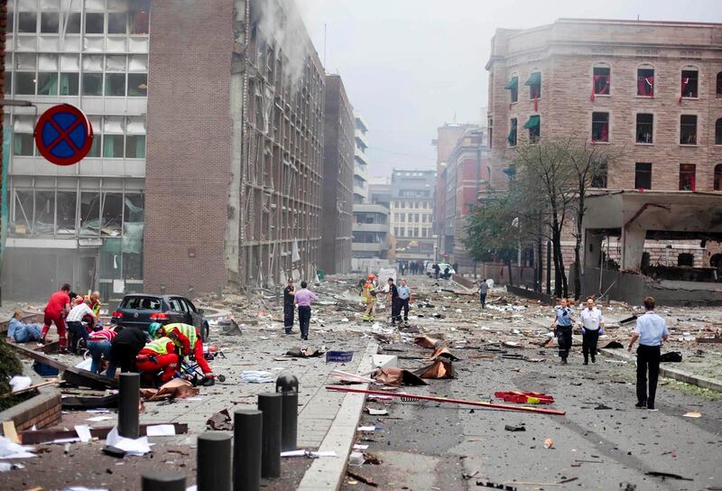 Victims receive treatment outside government buildings in the center of Oslo, Friday July 22, 2011, following an explosion that tore open several buildings including the prime minister's office, shattering windows and covering the street with documents. (AP Photo/Fartein Rudjord) *** Local Caption ***  Norway Explosion.JPEG-06cd3.jpg