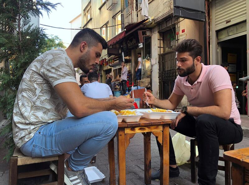 Yousef Abbas, left, and his friend Fadi Farousi, both from Syria, pass time at an Istanbul neighbourhood where many Syrians live. Abbas from Aleppo, is registered in the city of Izmir, Turkey but works in Istanbul's vast tourism sector. "I am afraid. I don't go out. Why? Because I would get caught," he says. Syrians say Turkey has been detaining and forcing some Syrian refugees to return back to their country the past month. AP Photo