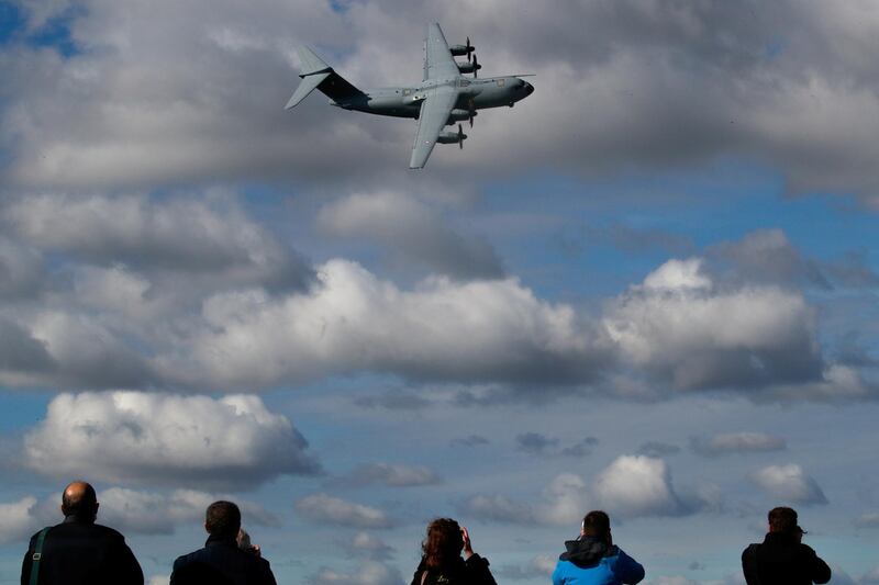Photographers work as a French Air Force Airbus A400M performs during a presentation of the French Air and Space Army at the BA 105 Evreux-Fauville Air Force Base, France. Reuters