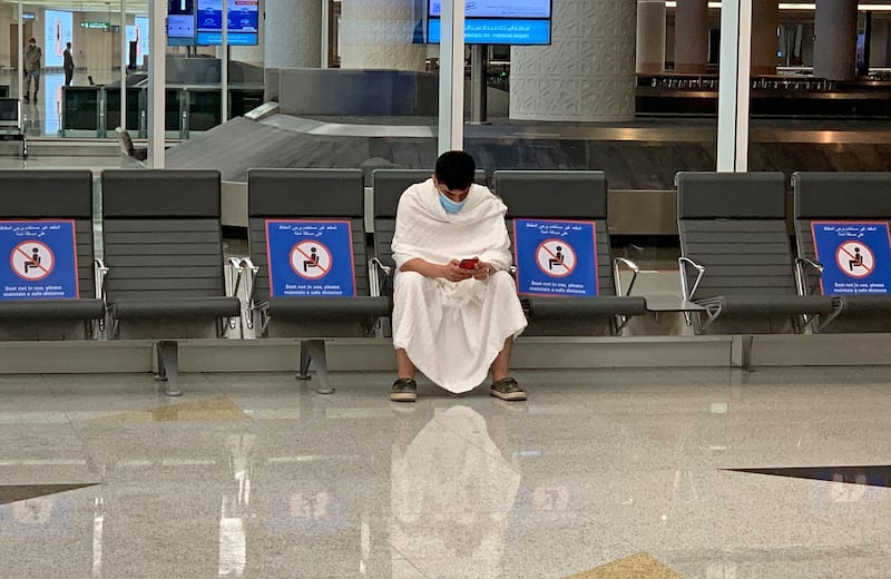 A pilgrim waits for his luggage at King Abdulaziz International Airport in Jeddah. Before the pandemic, the Hajj drew 2. 5 million pilgrims to Saudi Arabia.