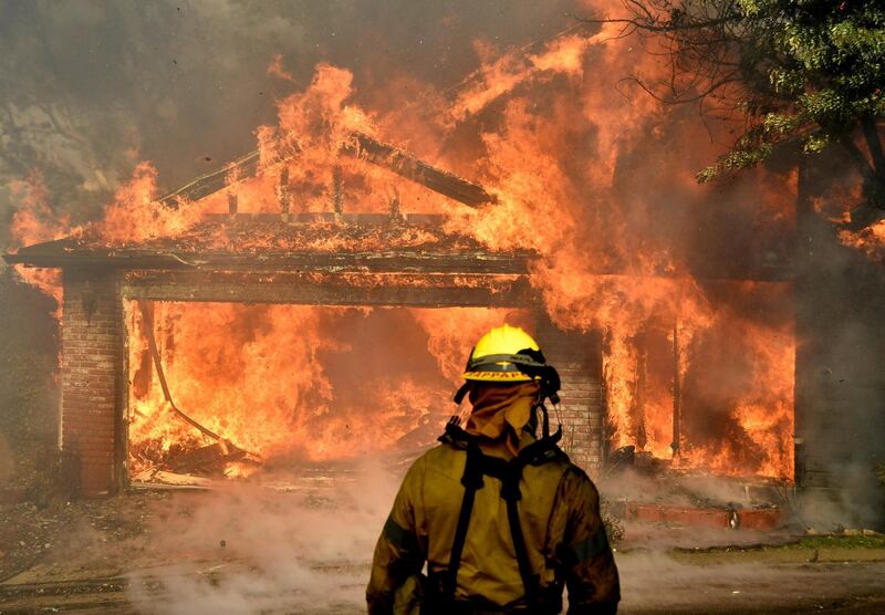 Firefighters battle to save one of many homes burning in the Kagel Canyon area of the San Fernando Valley during an outbreak of California wildfires. Gene Blevins / Reuters