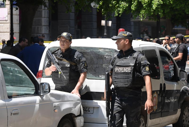 Tunisian security forces stand guard at the site of an attack in the Tunisian capital's main avenue Habib Bourguiba.   AFP