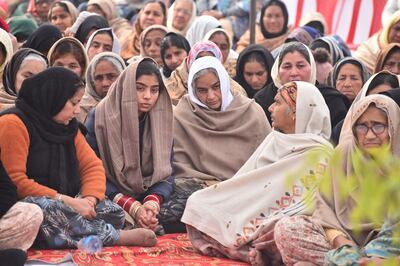 Abu Dhabi blast victim Hardeep Singh's wife Kanupriya Kaur and his mother Charanjit Kaur surrounded by grieving relatives at a prayer ceremony in Mehsampur village in northern India to mark 10 days since his death. Prabhjot Singh Gill for The National