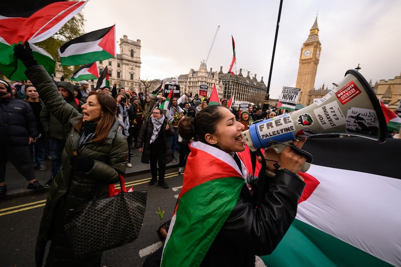 A woman leads a chant as Pro-Palestinian protesters gather in Parliament Square in London to call for an end to arms support to Israel. Getty Images