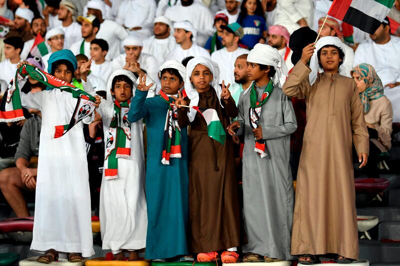 Emirati boys cheer ahead of the football game. AFP