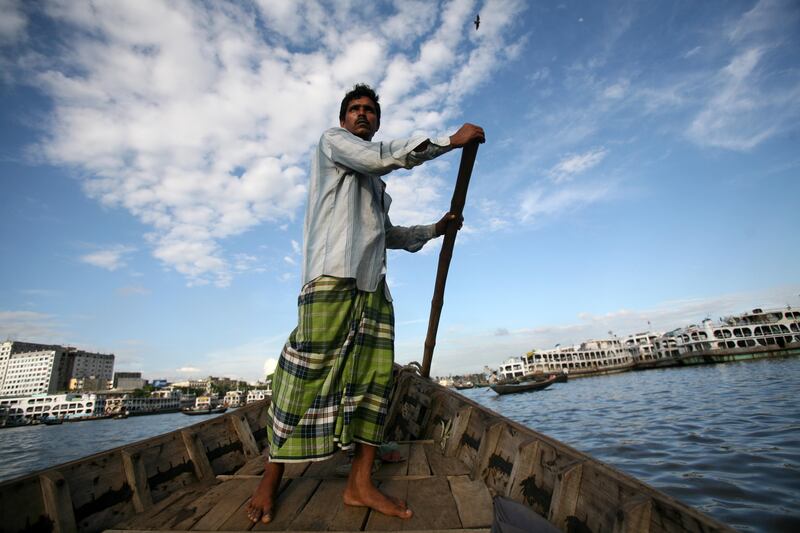 Dhaka, Bangladesh - June 12, 2008 - A fisherman guides his dow through the Sadarghat Boat Terminal.   (Nicole Hill / The National) *** Local Caption ***  NH Bangladesh409.jpgNH Bangladesh409.jpg