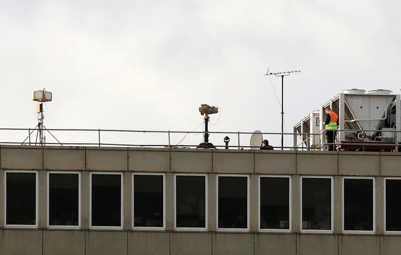 Counter drone equipment deployed on a rooftop at Gatwick airport as the airport and airlines work to clear the backlog of flights delayed by a drone incident earlier in the week, in Crawley, England,  Saturday, Dec. 22, 2018.  London's Gatwick Airport took strides toward running a full schedule Saturday as police questioned a man and a woman in connection with the drone intrusions that caused mayhem for tens of thousands of holiday travelers. (Gareth Fuller/PA via AP)