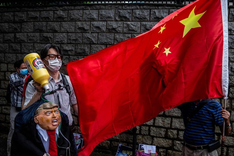 TOPSHOT - A pro-China activist holds an effigy of US President Donald Trump during a protest outside the US consulate in Hong Kong on May 30, 2020, in response to US President Donald Trump saying on May 29 he would strip several of Hong Kong's special privileges with the United States and bar some Chinese students from US universities in anger over Beijing's bid to exert control in the financial hub.  / AFP / ISAAC LAWRENCE
