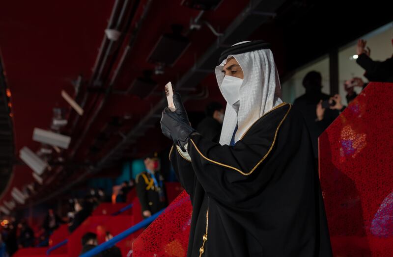Sheikh Mansour takes a photograph during the opening ceremony.