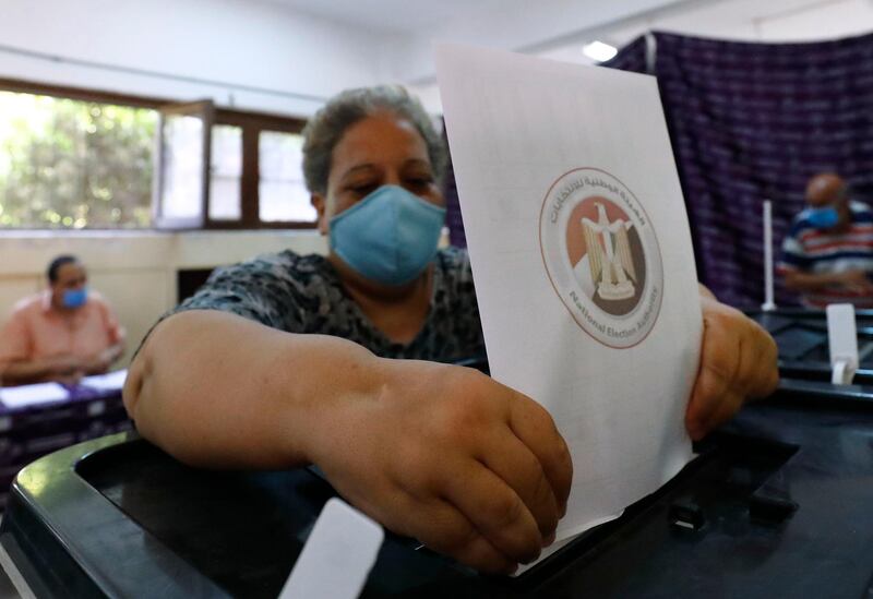 An Egyptian woman casts her vote at polling station. AFP