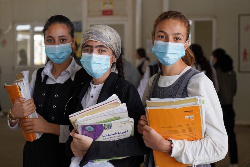 Girls pose for a picture before going to class on the first day of school in a Yazidi displaced persons camp in the Sharya area, about 15 kilometres from the city of Dohuk in Iraqi Kurdistan. AFP