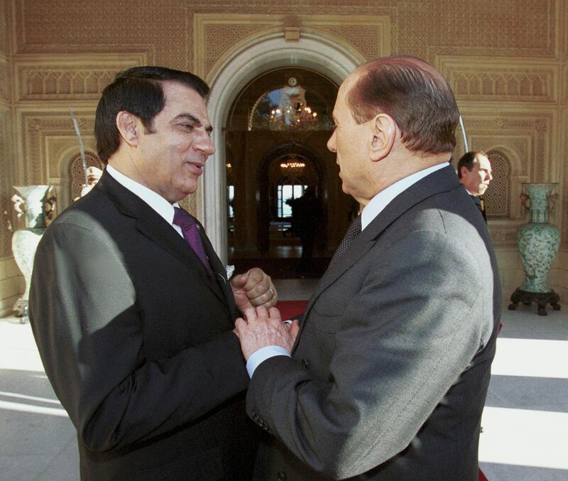 Former Tunisian president Zine El Abidine Ben Ali greets Mr Berlusconi at the presidential palace in Tunis in November 2001. AFP