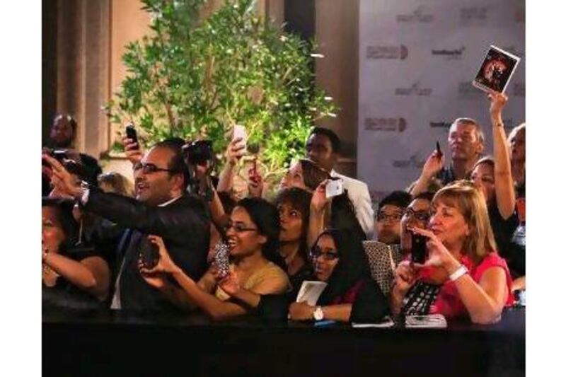 Fans snap photos as Richard Gere arrives at the Abu Dhabi Film Festival on Friday. The festival offers both hard-to-find movies and also a lively scene, a reader says. Lee Hoagland / The National