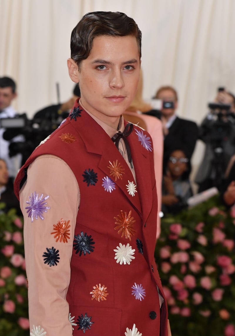 Actor Cole Sprouse wore a boldly embroidered shirt and contrasting sleeveless jacket for the event. AFP