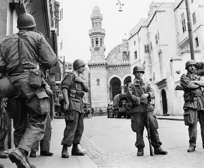 FILE - In this May 27, 1956 file photo, French troops seal off Algiers' notorious casbah, 400-year-old teeming Arab quarter. French President Emmanuel Macron has formally recognized that the French state was responsible for the death of a dissident mathematician in Algeria in 1957, admitting for the first time the French military's "system" of torture during Algeria's independence war. (AP Photo)