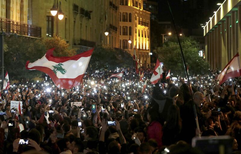 Lebanese demonstrators use their phone lights during an anti-government protest in Beirut. AFP