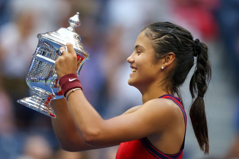 Emma Raducanu of Great Britain celebrates with the championship trophy after defeating Leylah Annie Fernandez of Canada. Getty Images