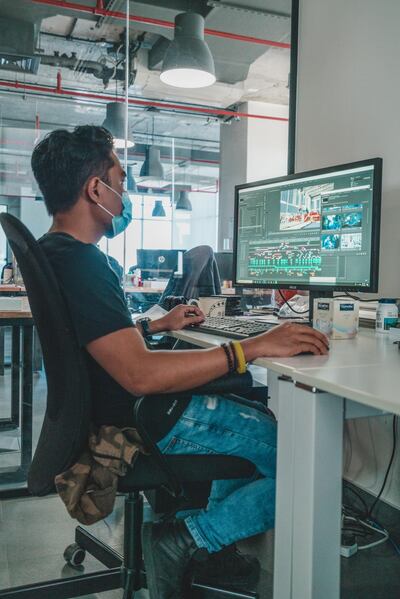 A team member wears a yellow wristband, which indicates that they are happy to talk, but not touch, while sat at their desk. Courtesy Create Media Group 