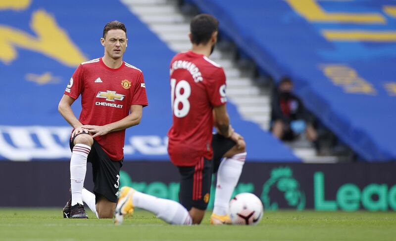 Nemanja Matic, left, and Bruno Fernandes of Manchester United take a knee before the start of the match. EPA