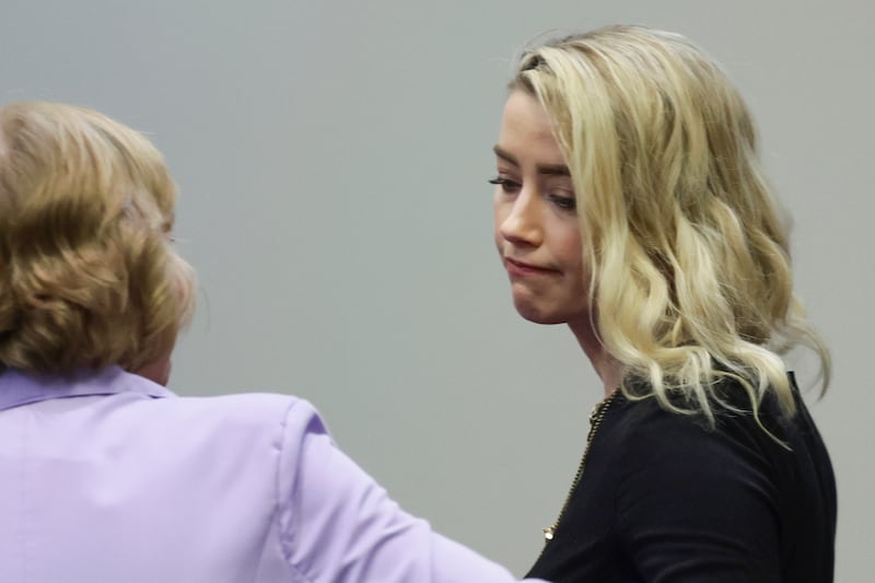 Heard reacts with her lawyer Elaine Bredehoft after the verdict was read at the Fairfax County Circuit Courthouse, Virginia, US, in June. AP