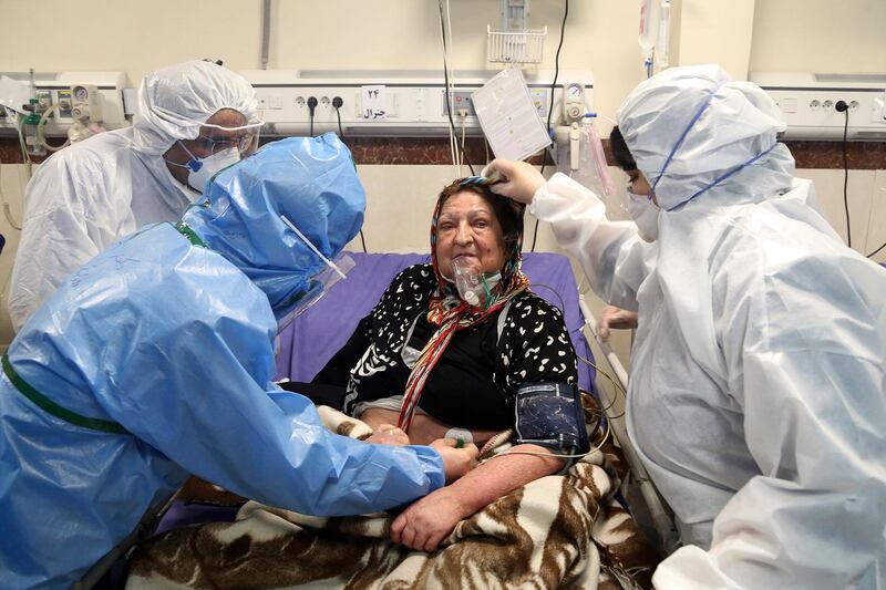 Medics treat a patient infected with the coronavirus, at a hospital in Tehran, Iran. AP Photo