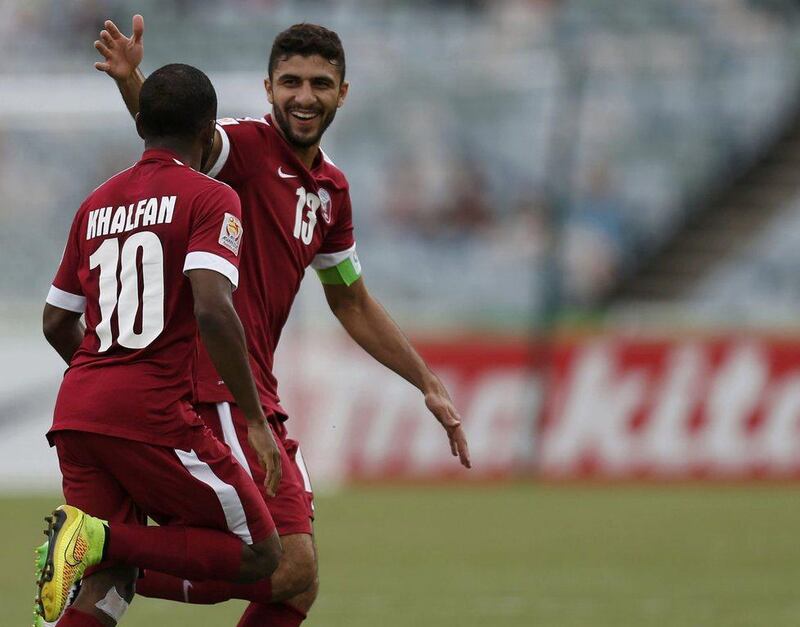 Qatar's Khalfan Ibrahim, left, celebrates scoring the opening goal on Sunday against the UAE in his side's eventual 4-1 Asian Cup loss. Tim Wimborne / Reuters