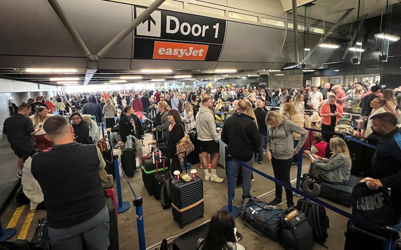 Passengers queue outside Terminal 1 after a power cut caused disruptions and cancellations at Manchester Airport in England on June 23.  Reuters