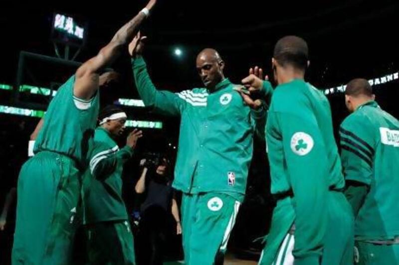 Boston Celtics' Kevin Garnett (C) slaps hands with teammates as he takes the court before the start of the first half of Game 1 of their NBA Eastern Conference semifinal playoff basketball series against the Philadelphia 76ers in Boston, Massachusetts May 12, 2012. REUTERS/Jessica Rinaldi (UNITED STATES - Tags: SPORT BASKETBALL) *** Local Caption *** BOS210_NBA-_0513_11.JPG