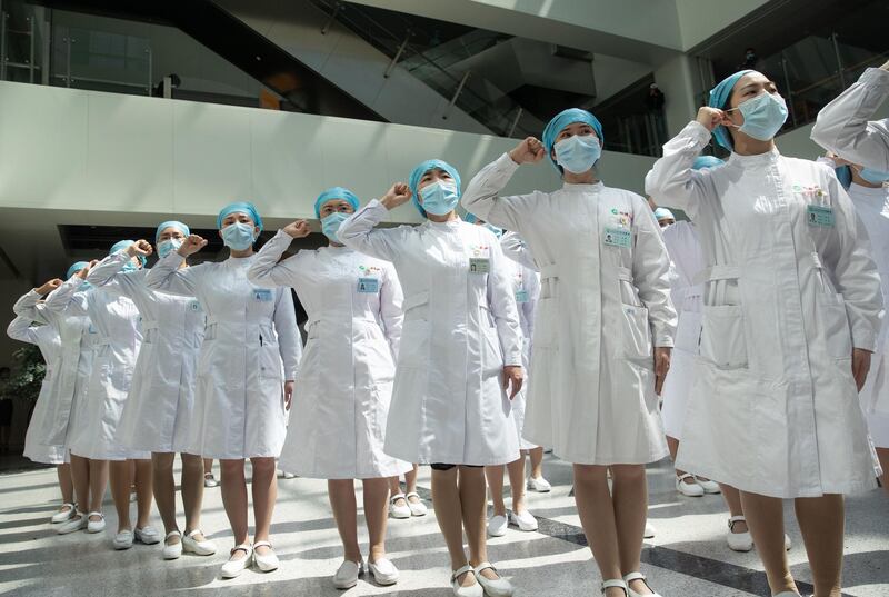 Nurses recite an oath during a ceremony marking International Nurses Day, at Tongji Hospital in Wuhan, in China's central Hubei province. AFP