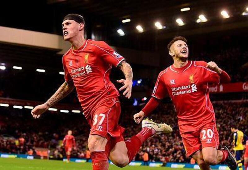Liverpool's Martin Skrtel, left, celebrates scoring his team's second equalising goal during their English Premier League football match against Arsenal at Anfield in Liverpool, Northwest England, on December 21, 2014. AFP PHOTO / PAUL ELLIS