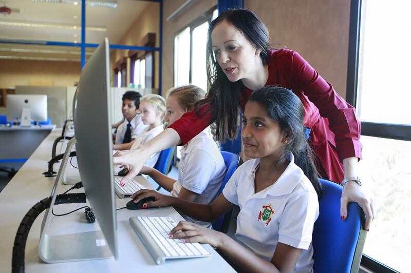 Roisin Duffy, head of wellbeing at Jumeirah Primary School, teaches students about internet safety at a computer lab. Sarah Dea / The National