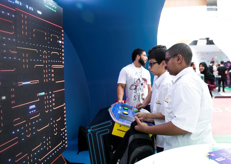 DUBAI, UNITED ARAB EMIRATES. 06 OCTOBER 2019. 
Schoolboys play pacman at Dubai Internet City booth at Gitex Technology Week at Dubai World Trade Center.

(Photo: Reem Mohammed/The National)

Reporter:
Section: