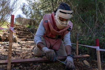 A Lebanese mine-clearer searches for unexploded ordnance in the Chouf region, Lebanon. Matt Kynaston for The National