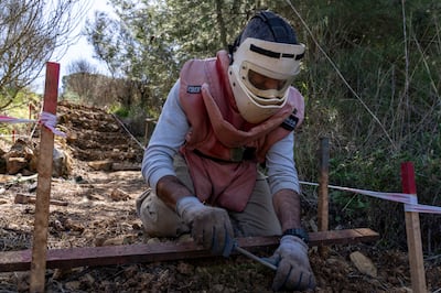 A Lebanese mine-clearer searches for unexploded ordnance in the Chouf region, Lebanon. Matt Kynaston for The National