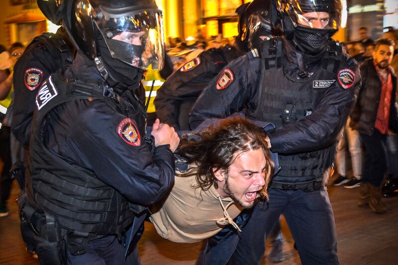 A protester is carried away from a demonstration in Moscow by police dressed in riot gear. AFP