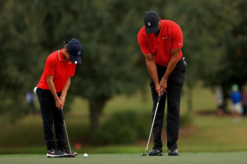 Tiger Woods and son Charlie practice putting on the 14th hole during the final round of the PNC Championship at the Ritz Carlton Golf Club. AFP