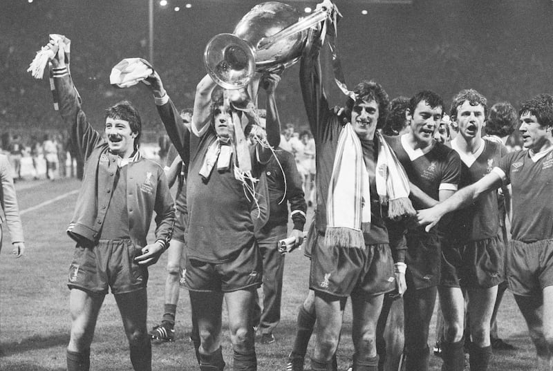 The players of Liverpool Football Club carry the trophy on a lap of honour after their 1-0 victory over FC Bruges in the European Cup final at Wembley Stadium. From left to right are Jimmy Case, Phil Neal, Ray Clemence, Ray Kennedy, David Fairclough and Emlyn Hughes.
(Photo by Central Press/Hulton Archive/Getty Images)